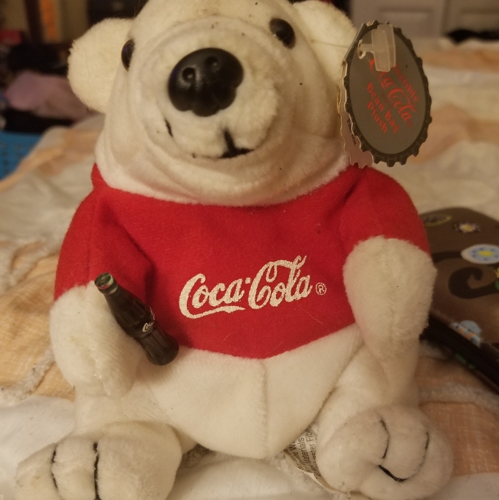An antique Coca-Cola bear with original tags made by Coca-Cola